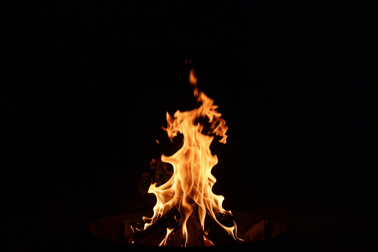 A single flame burning against darkness, illustrating the nature of God's character; fire does not choose to burn; it burns because that is what fire is.